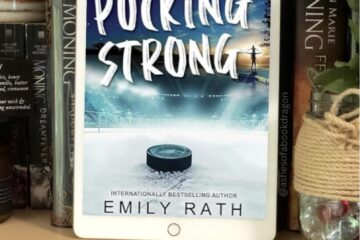 An reader sits on a book shelf showing the cover for novel Pucking Strong that has a hockey puck on an ice rink